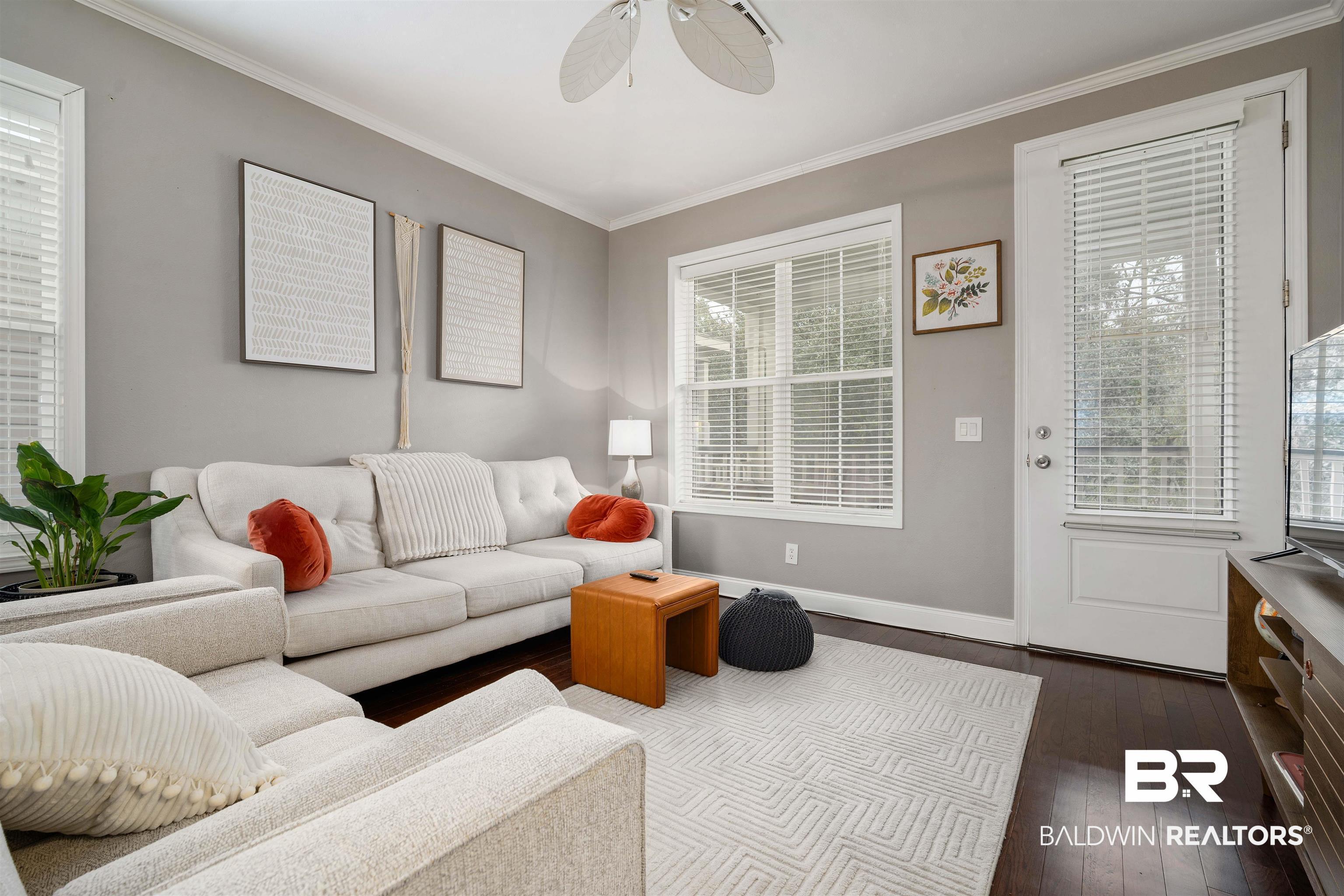 Image 4: Living area featuring dark wood-style floors, ornamental molding, and ceiling fan