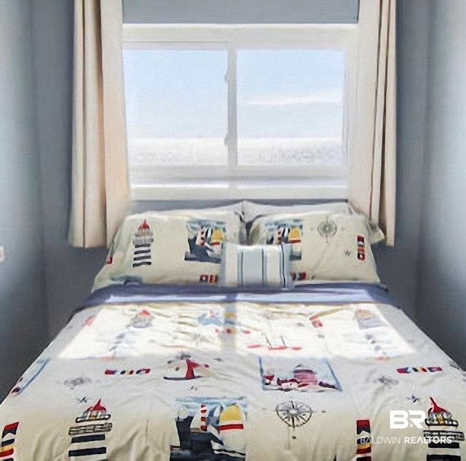 Image 4: Window with light-colored curtains and a serene outdoor backdrop