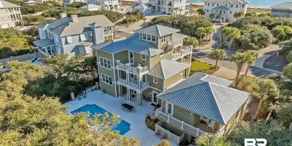 Image 2: Aerial view of residential area with a nearby body of water