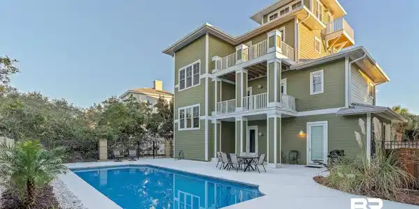 Image 3: Rear view of house with a patio and a balcony