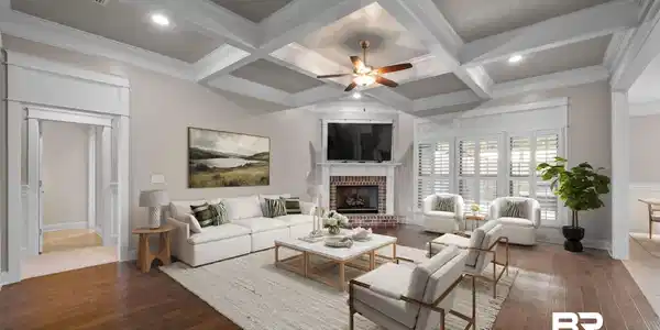 Image 2: Living area featuring a ceiling fan, coffered ceiling, wood-type flooring, a fireplace, and ornamental molding