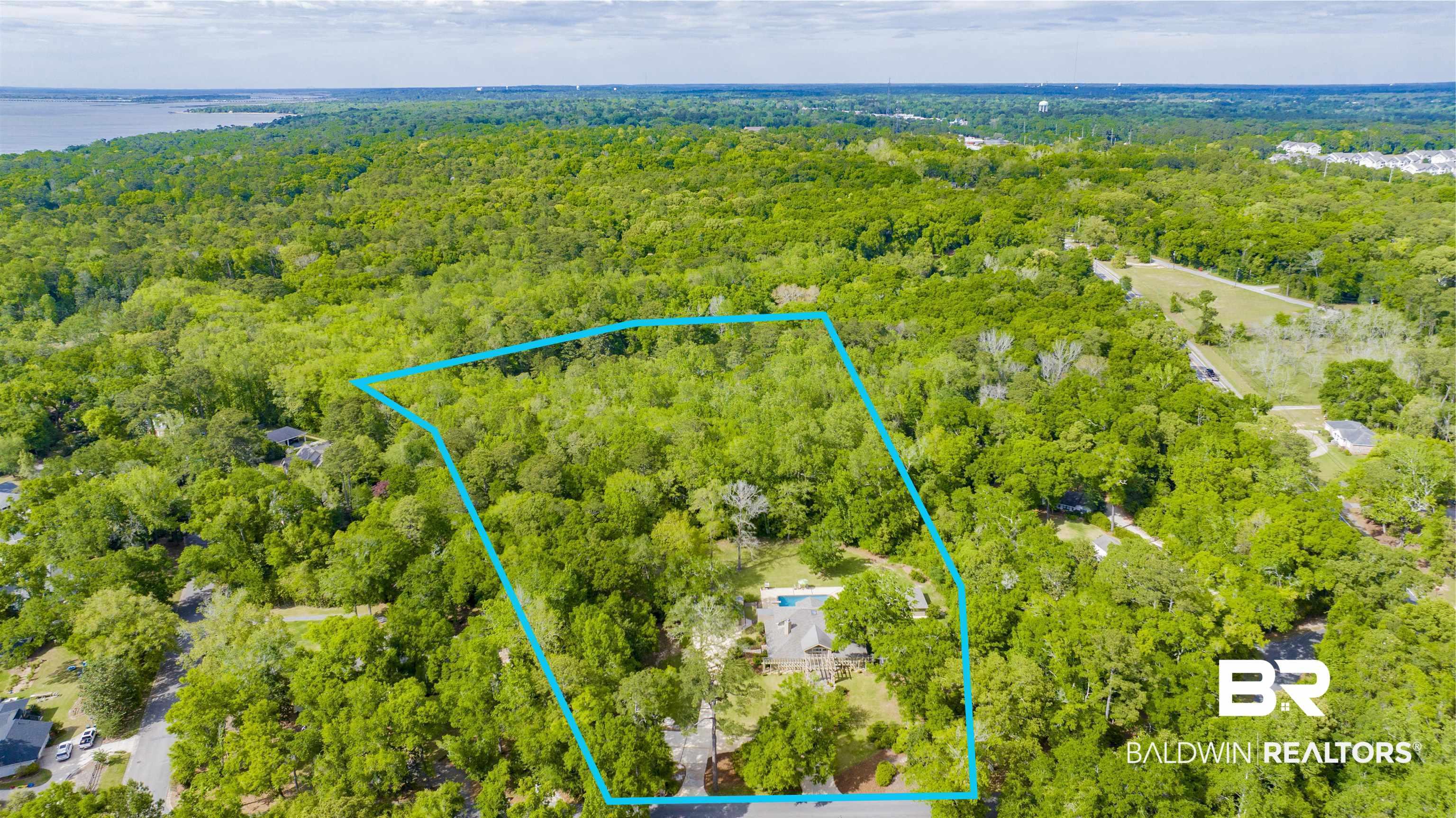 Image 4: Aerial view of property's location featuring a forest and property boundaries highlighted