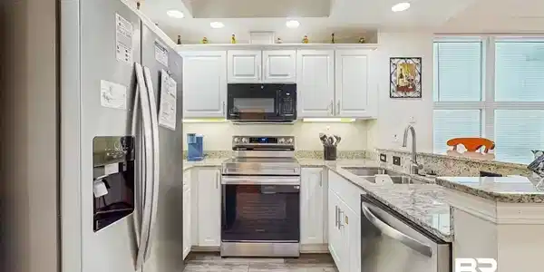 Image 4: Kitchen featuring stainless steel appliances, white cabinetry, recessed lighting, and granite countertops