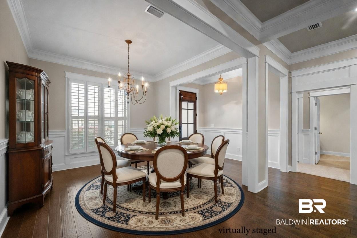 Image 4: Dining room featuring wainscoting, dark wood finished floors, a decorative wall, plenty of natural light, and crown molding