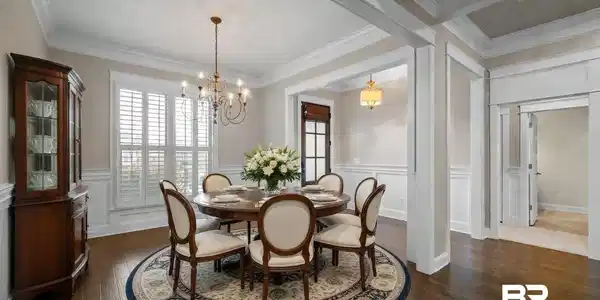 Image 4: Dining room featuring wainscoting, dark wood finished floors, a decorative wall, plenty of natural light, and crown molding