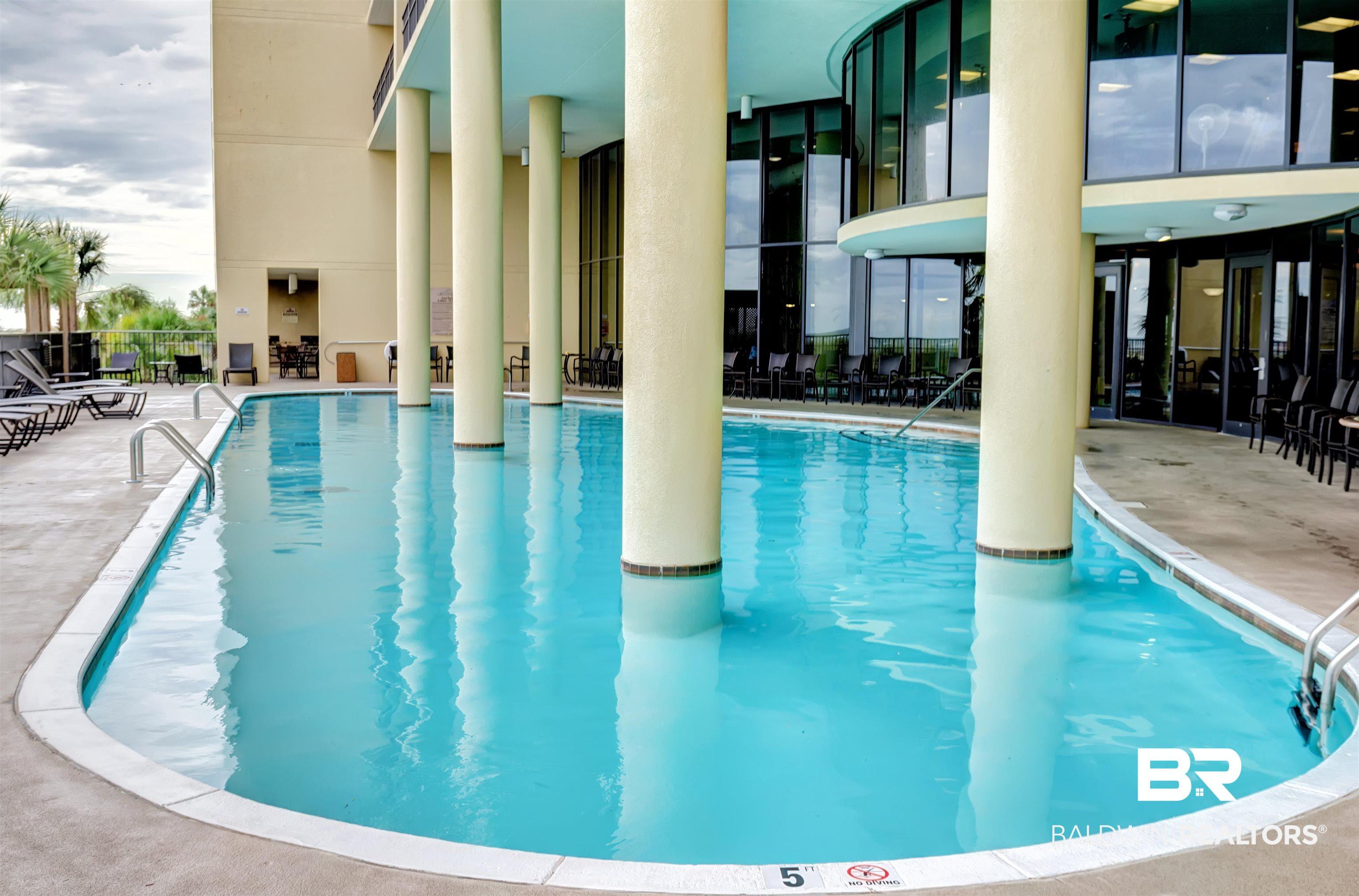 Image 3: Community pool featuring a patio