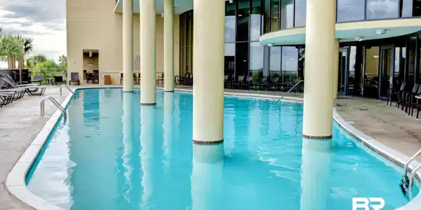 Image 3: Community pool featuring a patio