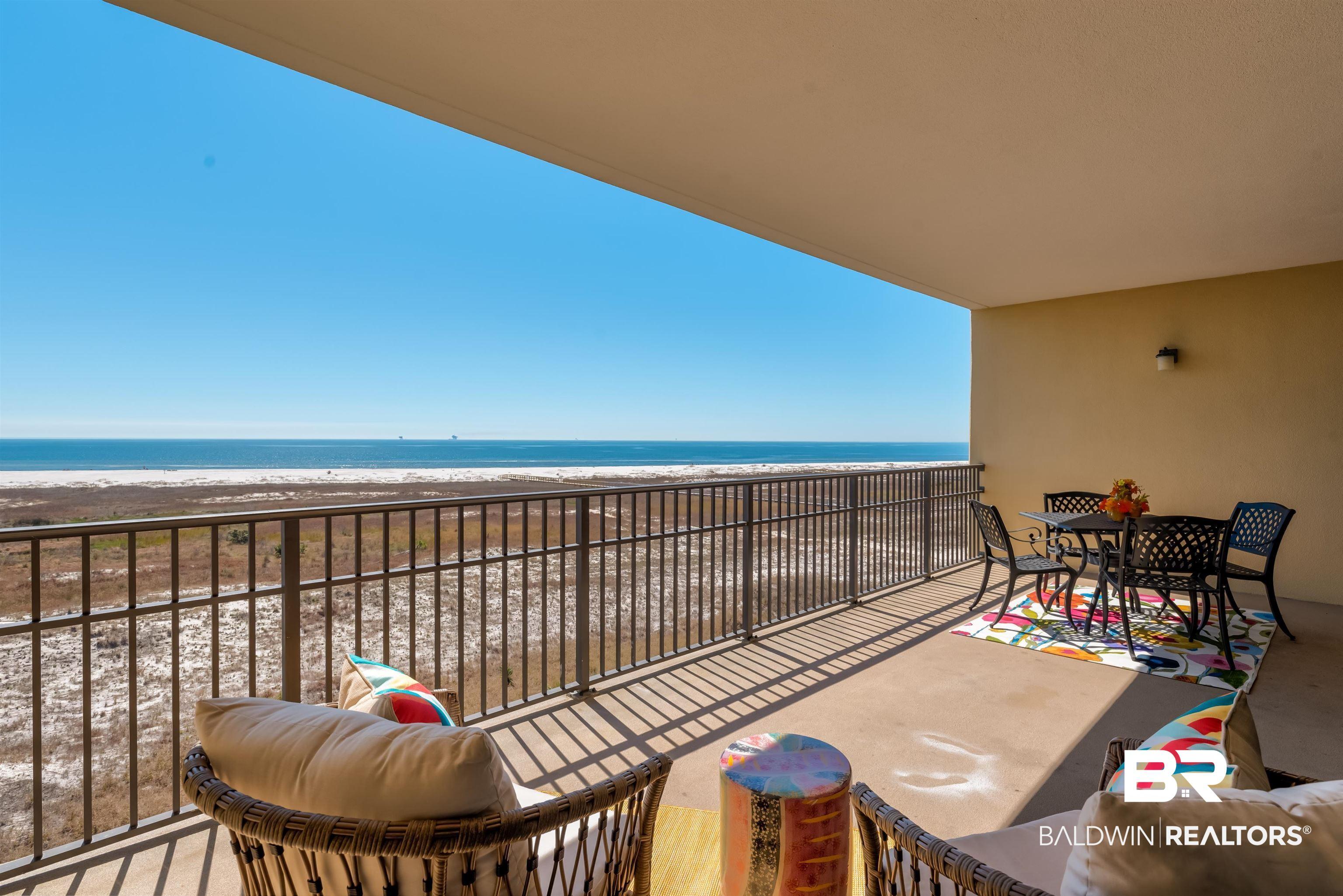 Image 4: Balcony featuring view of water and beach