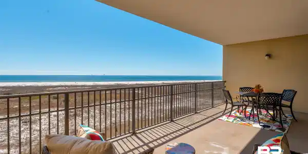 Image 4: Balcony featuring view of water and beach