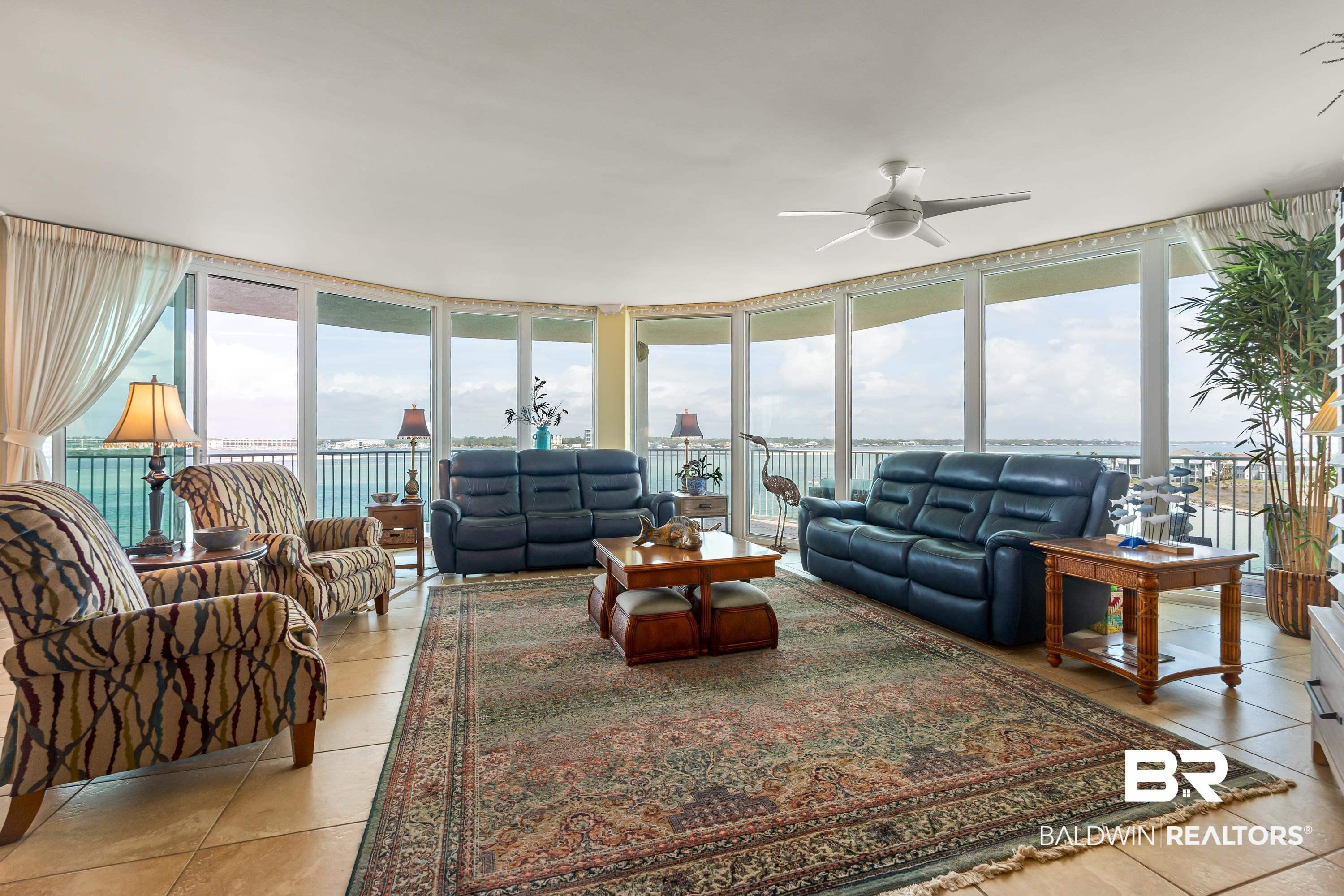 Image 3: Living area with expansive windows and ceiling fan