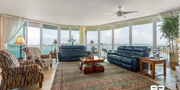 Image 3: Living area with expansive windows and ceiling fan
