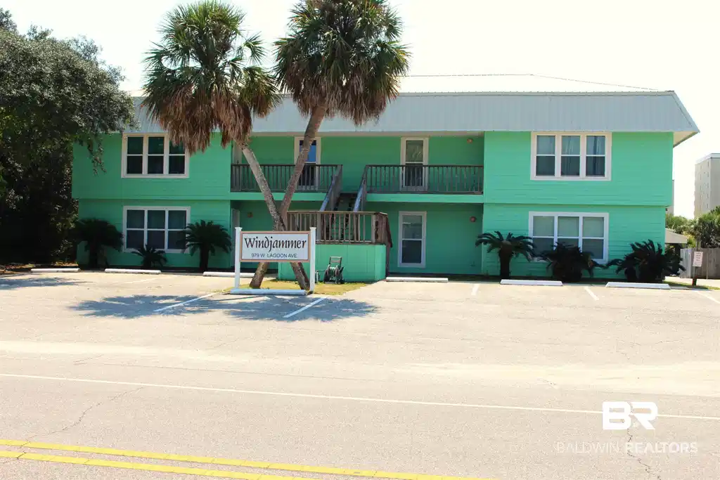 Image 1: View of building exterior with uncovered parking