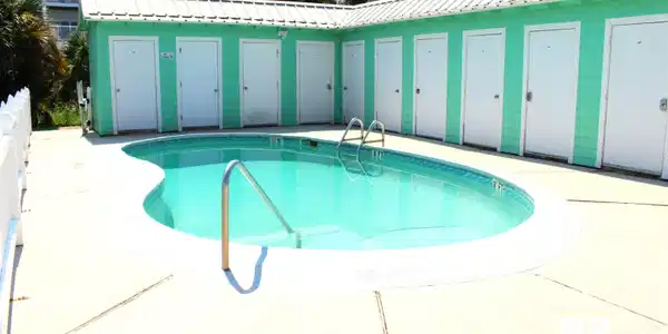 Image 3: Community pool with a patio area