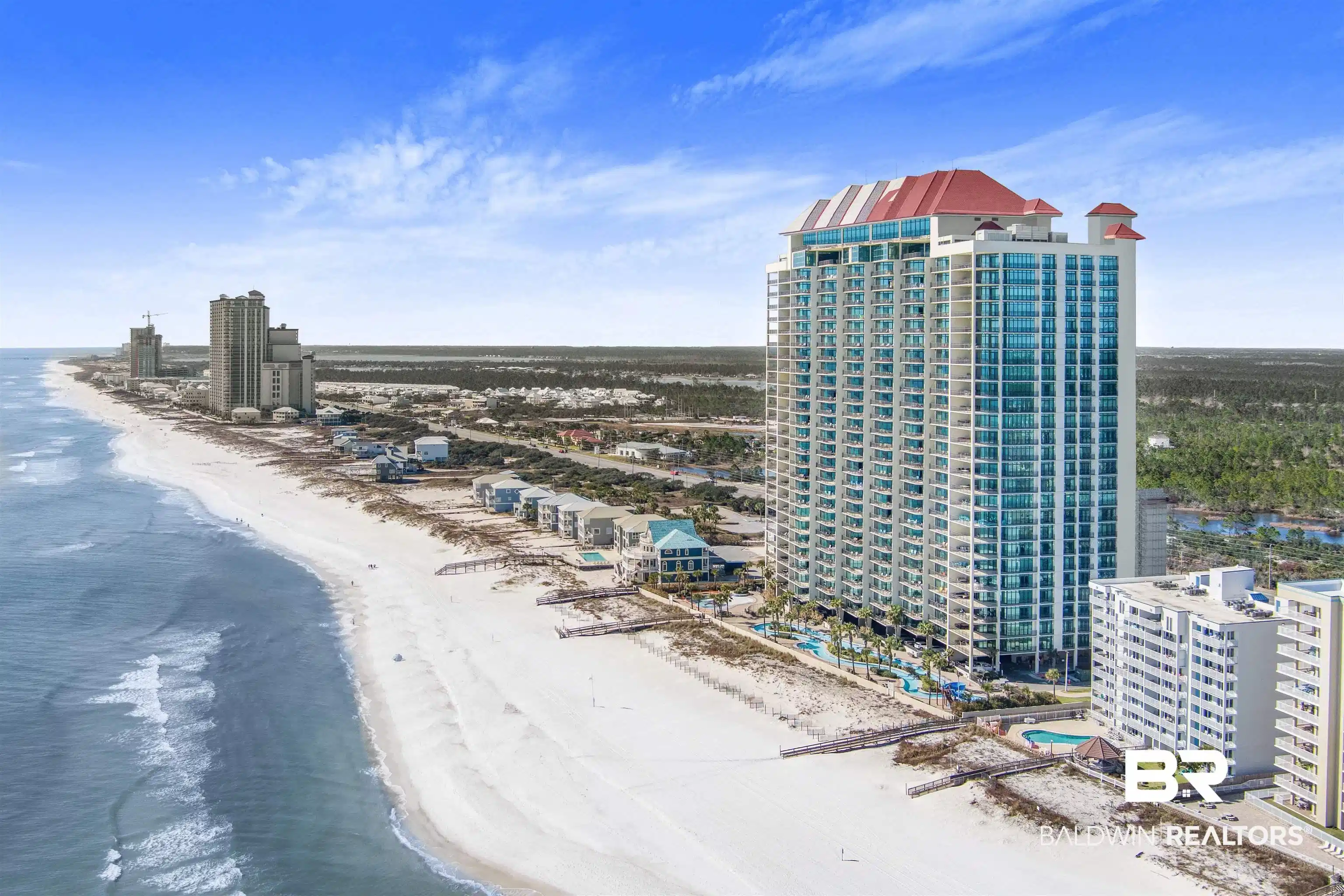 Image 1: Multi-story waterfront high-rise featuring a red-tiled roof and multiple balconies