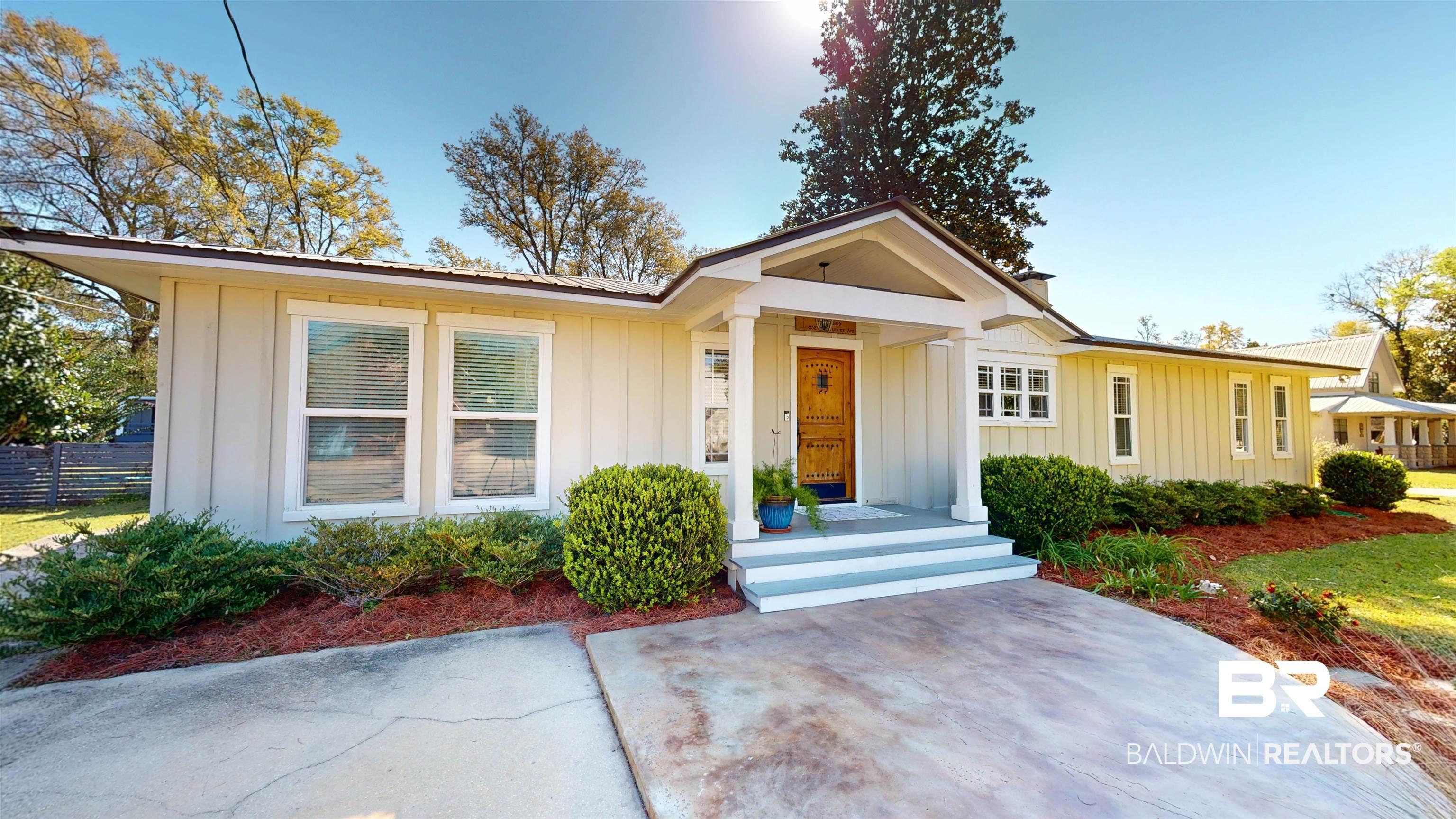 Image 3: View of front facade featuring board and batten siding