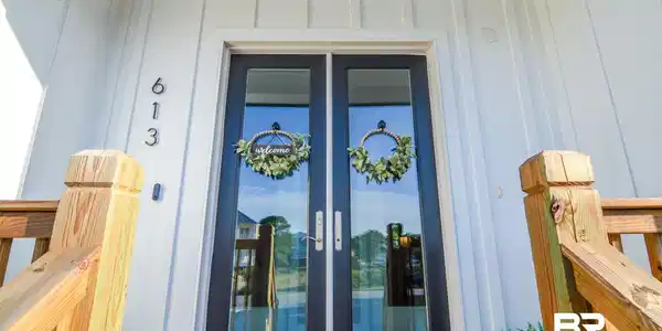 Image 2: Property entrance featuring board and batten siding