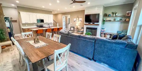 Image 4: Dining space featuring light wood finished floors, crown molding, recessed lighting, a fireplace, and a ceiling fan