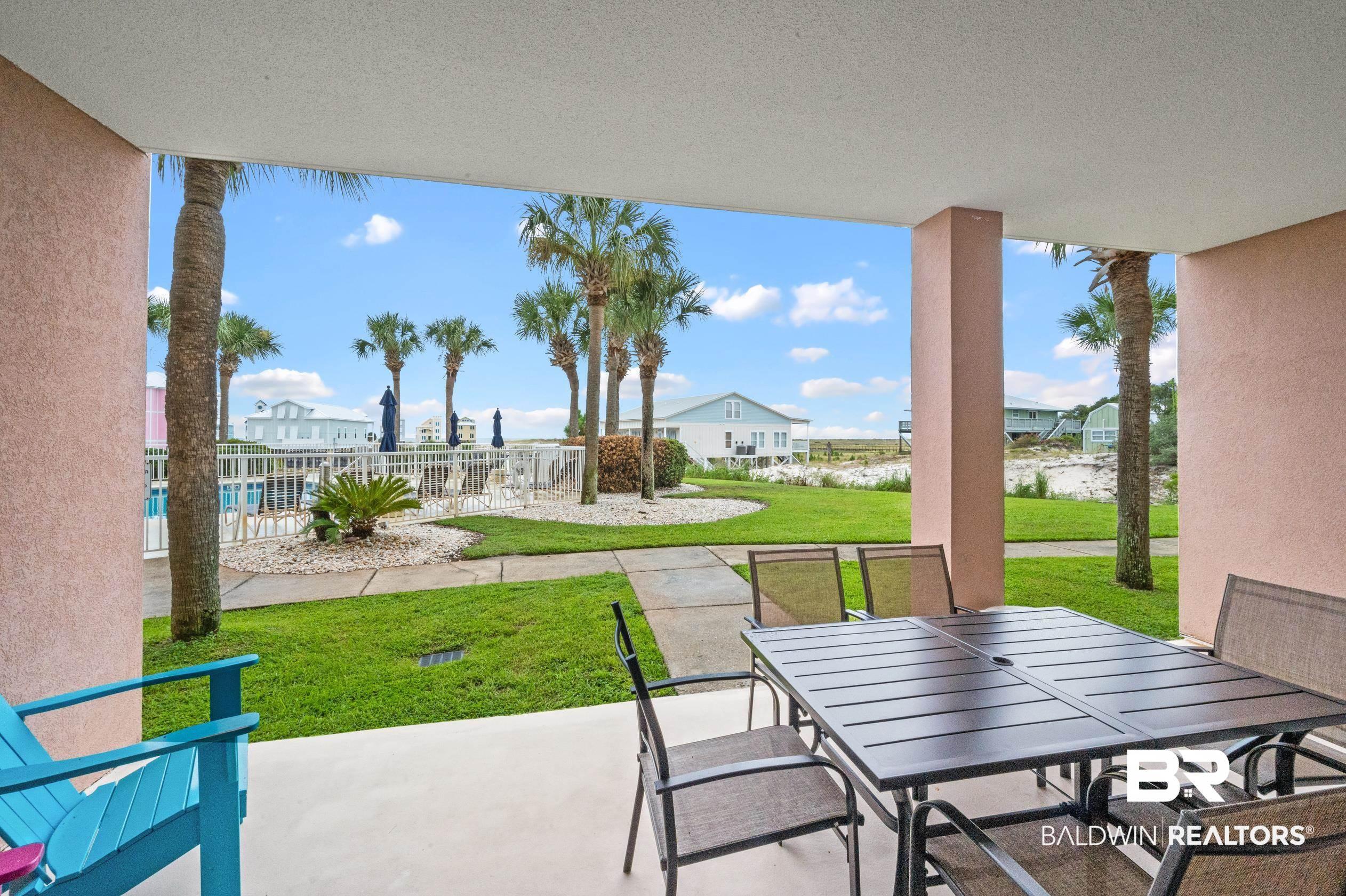 Image 3: View of patio featuring outdoor dining space and fence