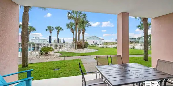 Image 3: View of patio featuring outdoor dining space and fence