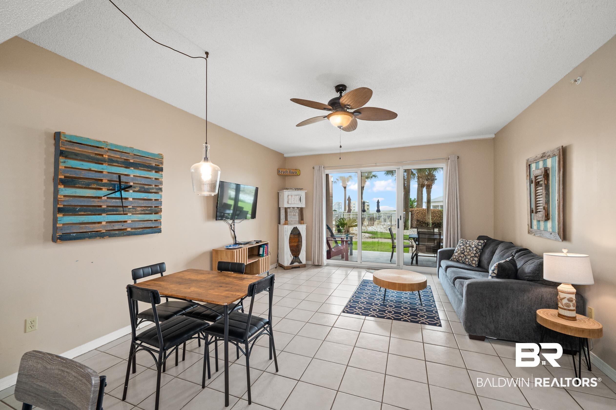 Image 4: Dining space with light tile patterned floors, baseboards, and a ceiling fan