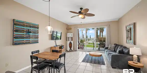 Image 4: Dining space with light tile patterned floors, baseboards, and a ceiling fan