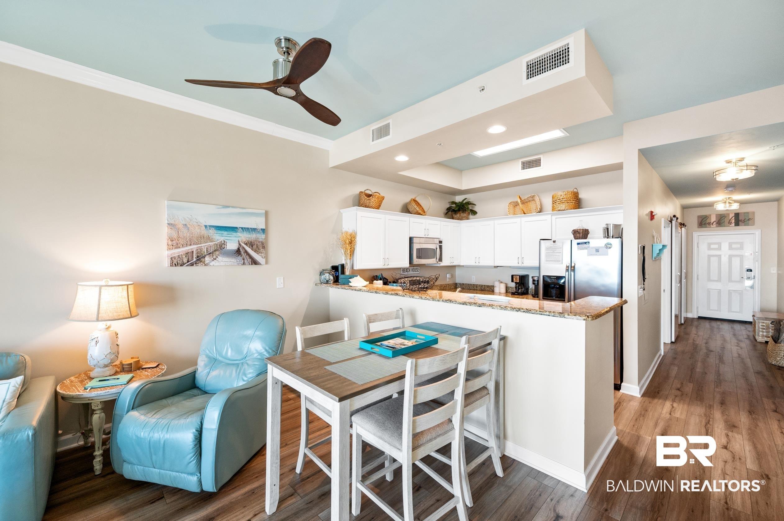 Image 4: Dining space with ornamental molding, visible vents, baseboards, and wood finished floors