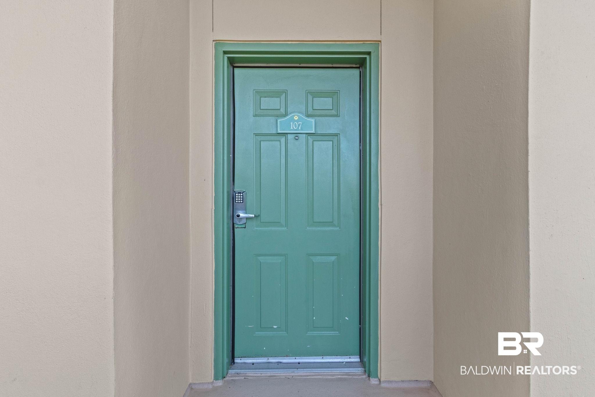 Image 2: Property entrance with stucco siding