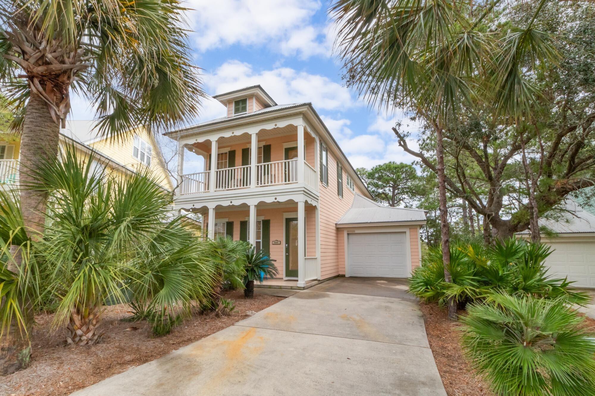Image 2: View of front facade with a balcony, covered porch, a garage, and driveway