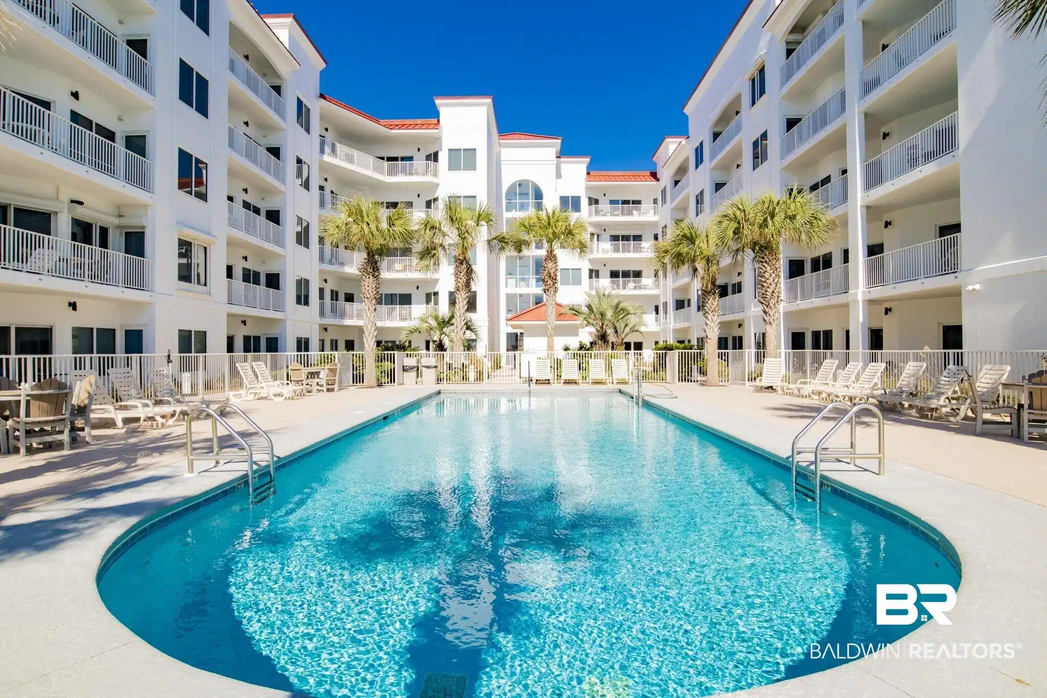 Image 1: Community pool with a patio area