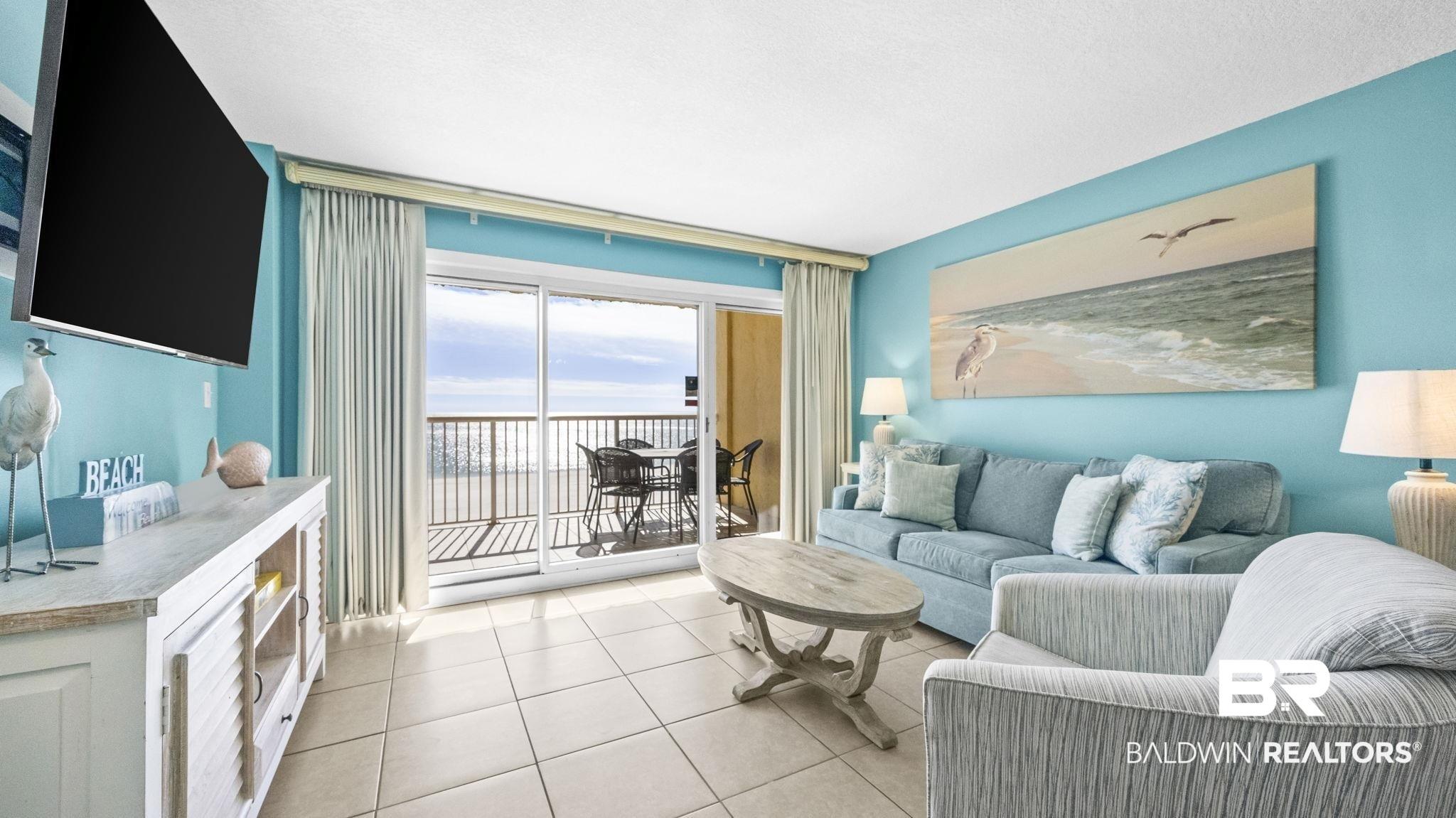 Image 3: Living area featuring light tile patterned flooring