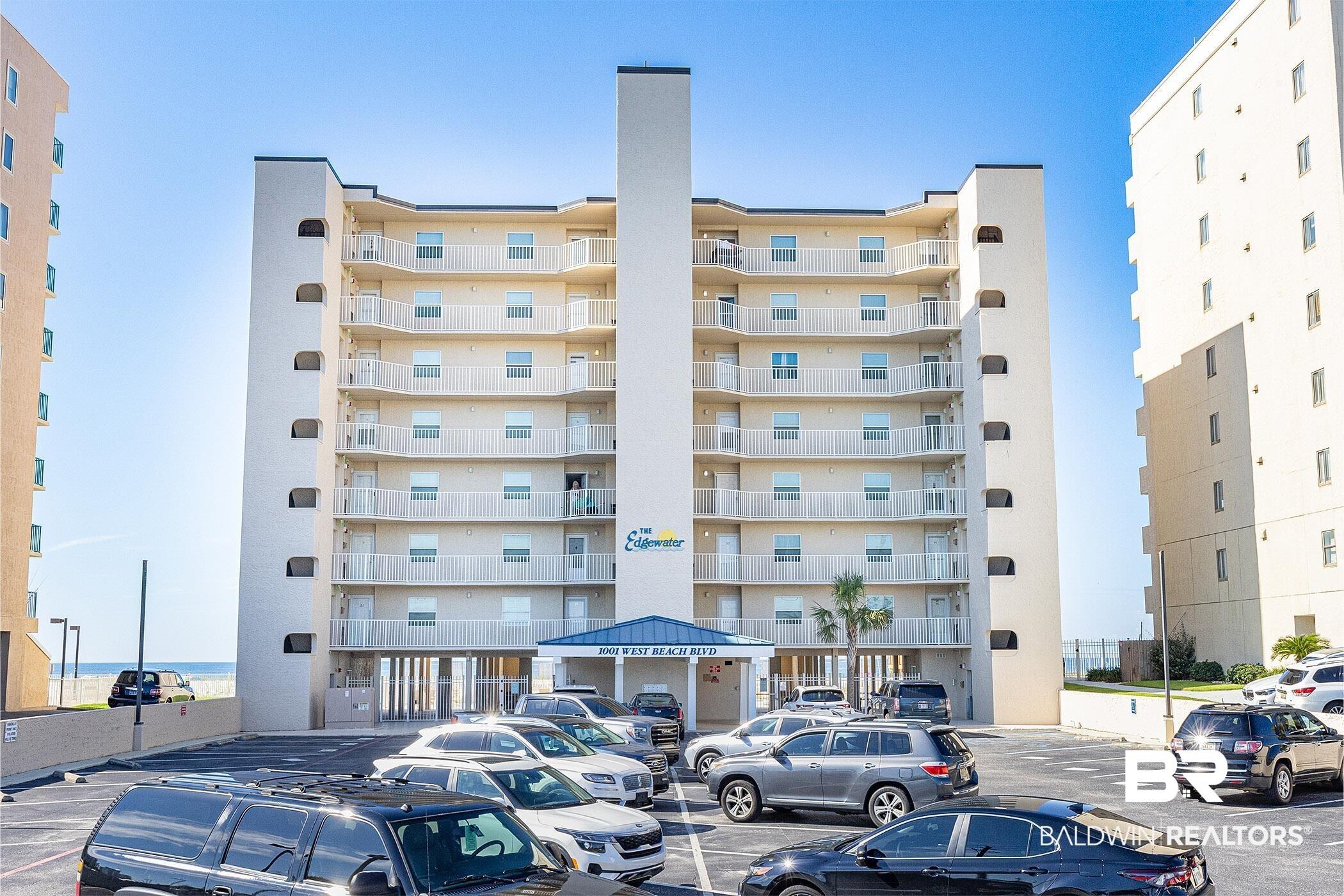 Image 3: View of apartment building / complex featuring uncovered parking