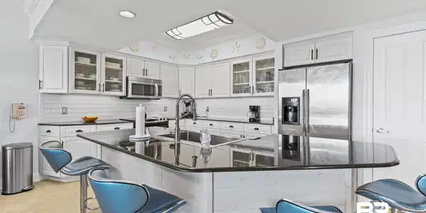 Image 3: Kitchen featuring white cabinetry, subway tile backsplash, stainless steel appliances, a center island with a dark countertop, and recessed lighting