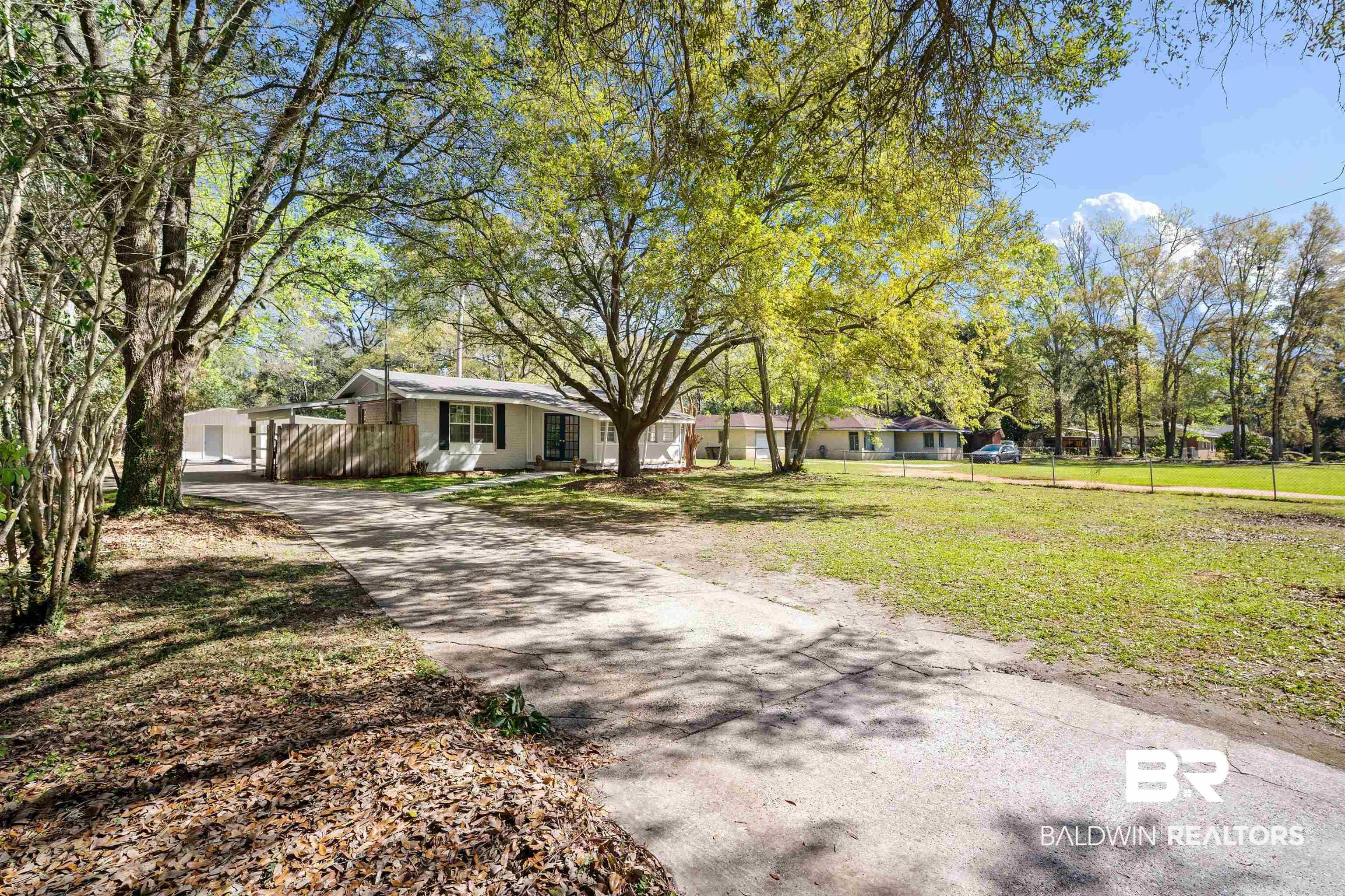 Image 3: Ranch-style home with concrete driveway
