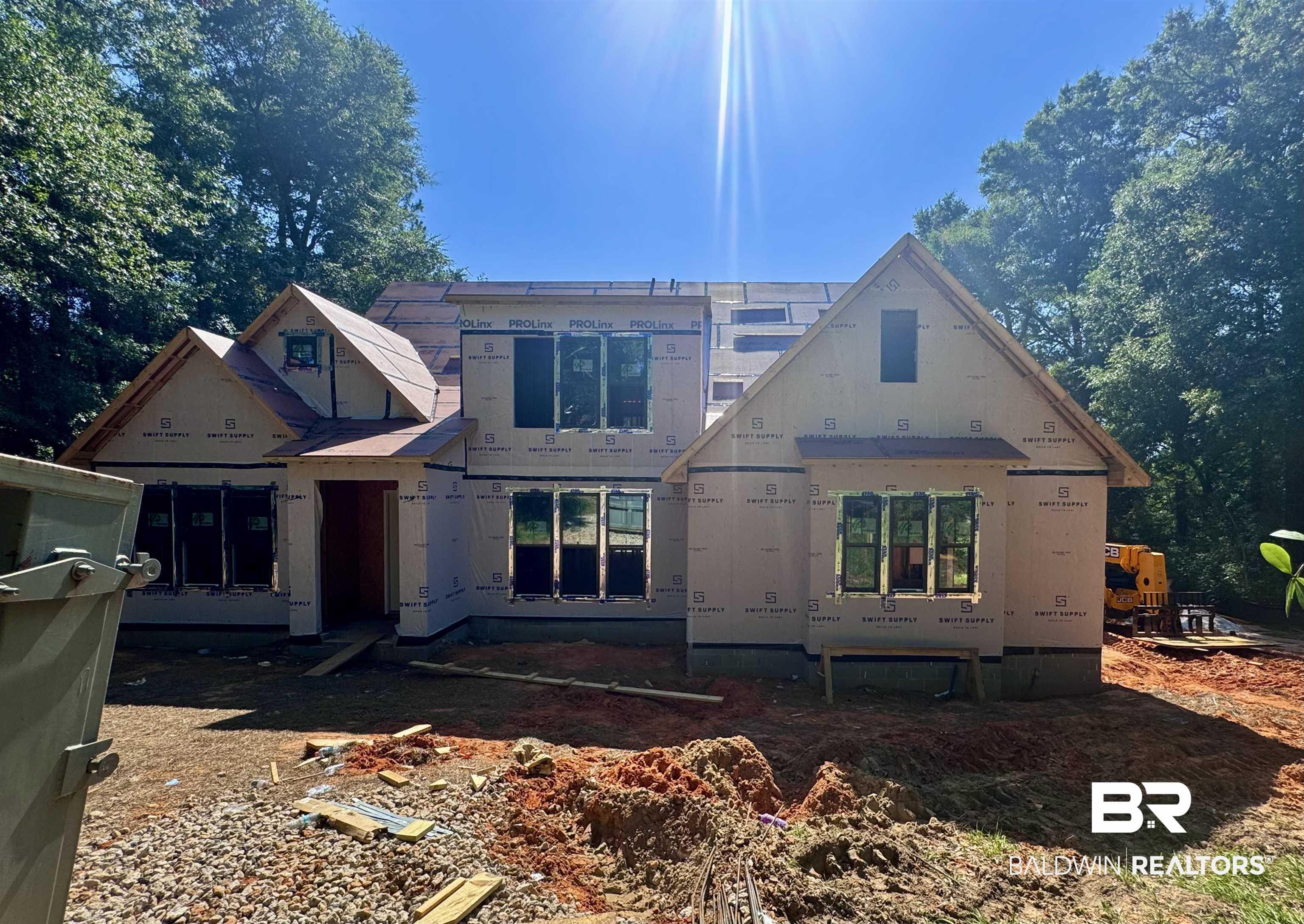 Image 2: New construction residence featuring a multi-gabled roofline and a partial second story