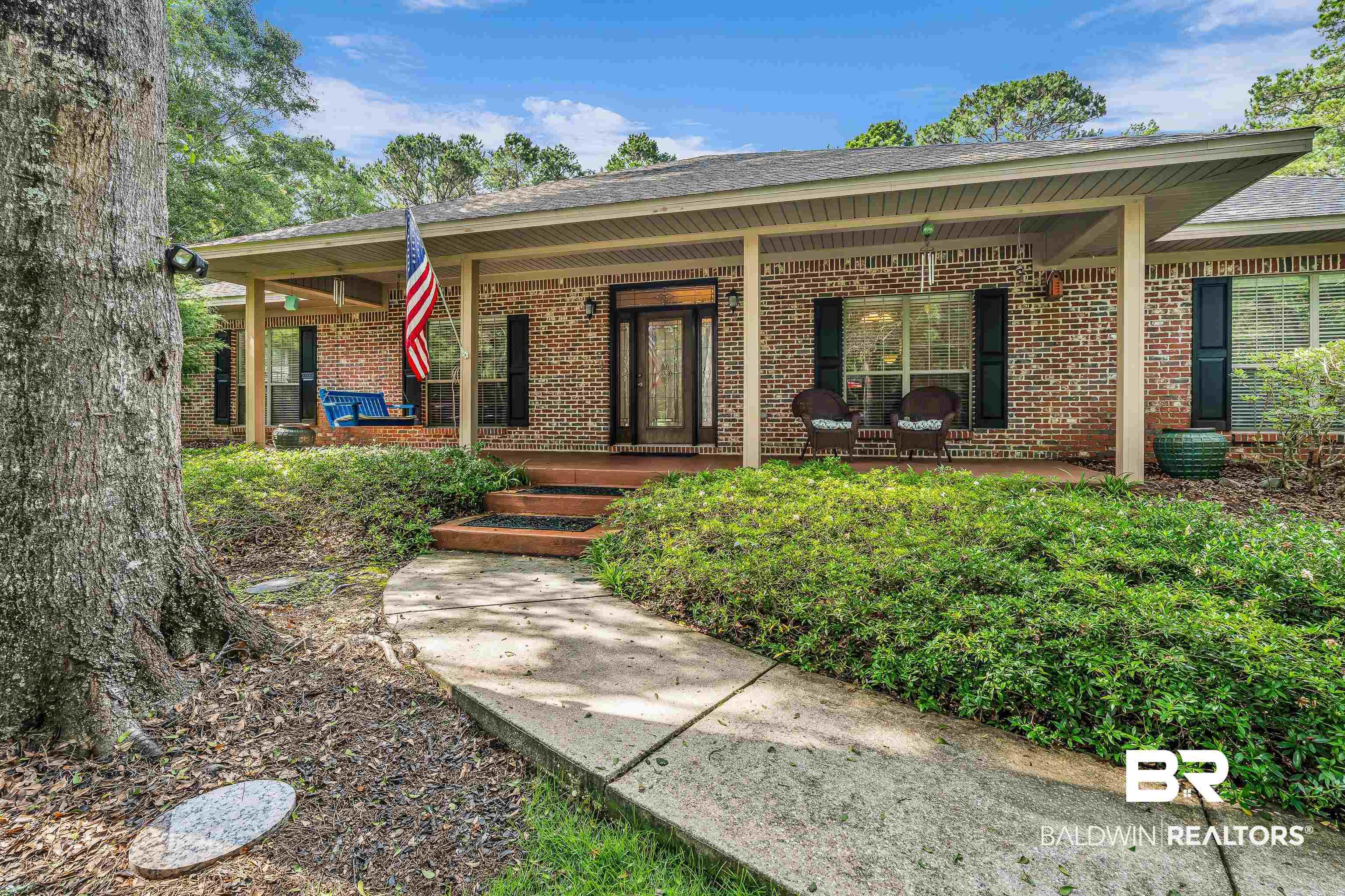 Image 1: Brick exterior with a covered porch