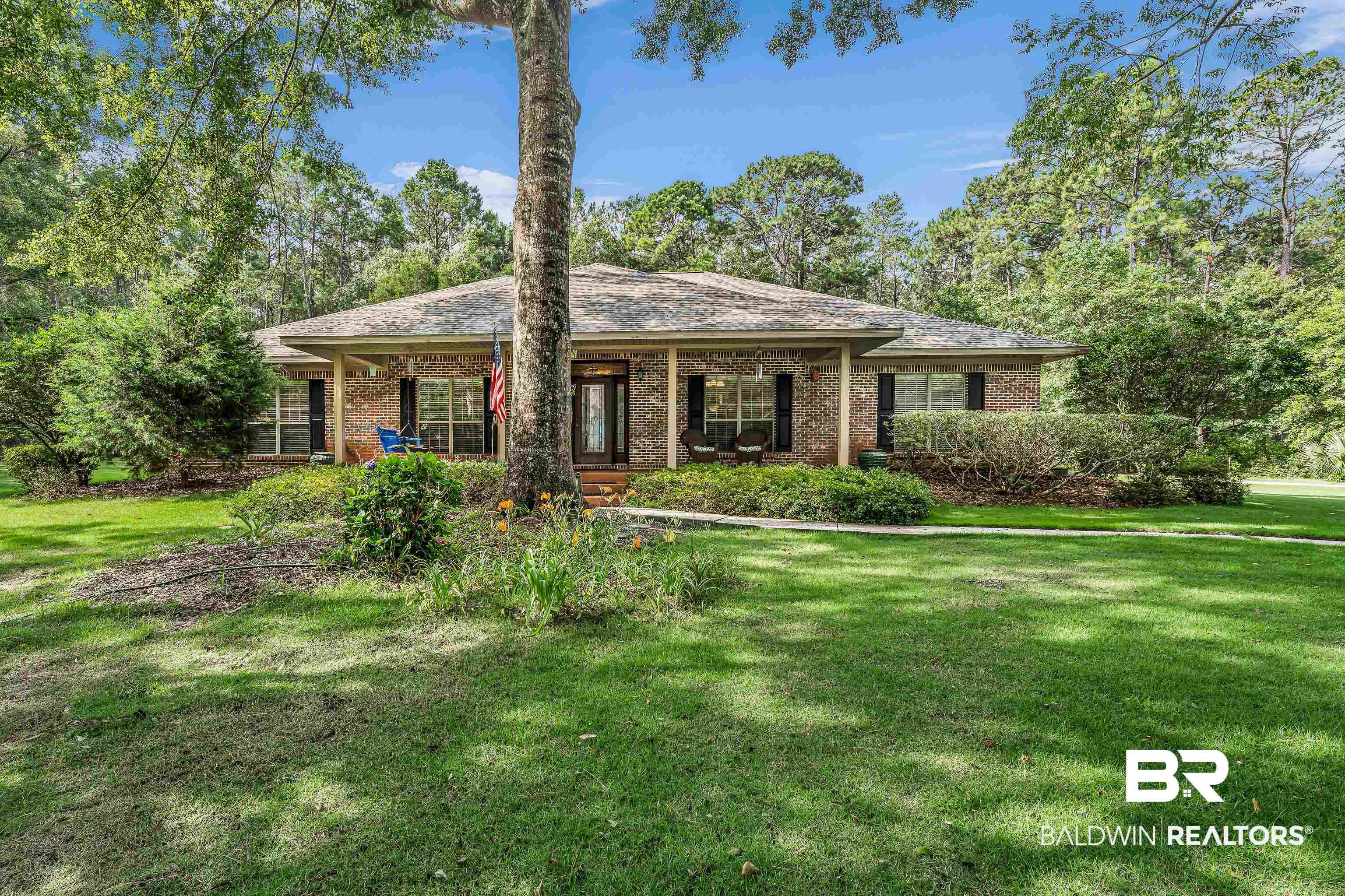 Image 4: Brick exterior with a covered front porch and dark shutters