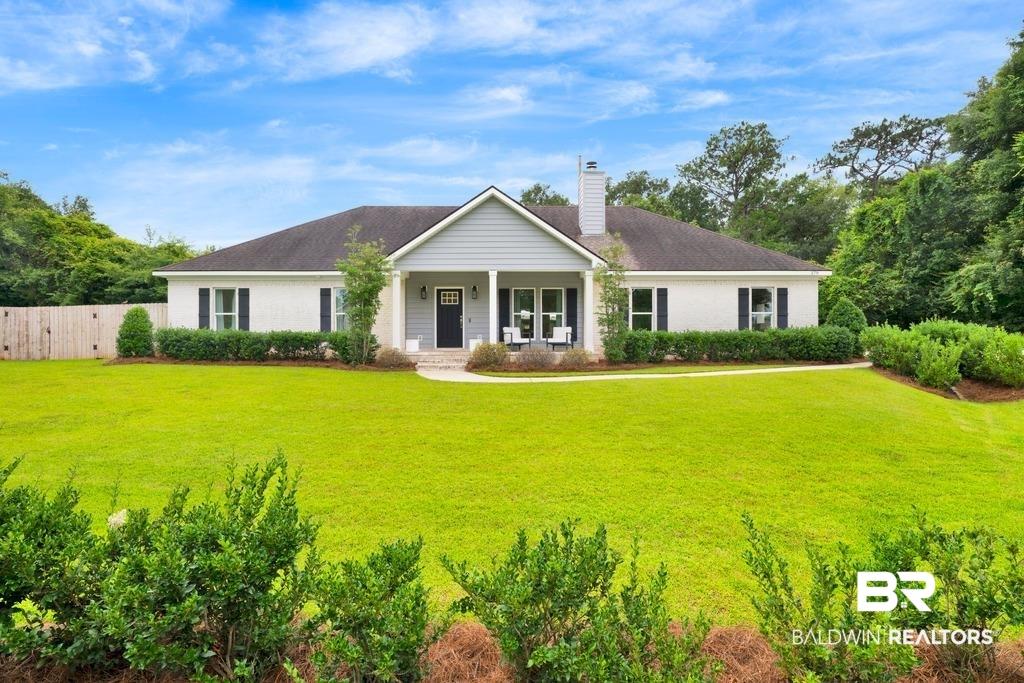 Image 1: White brick exterior with a contrasting gray siding gable