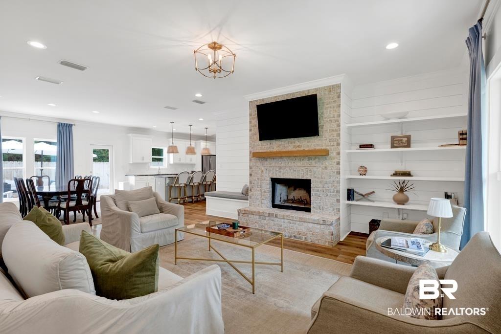 Image 3: Bright living area with wood-finish flooring