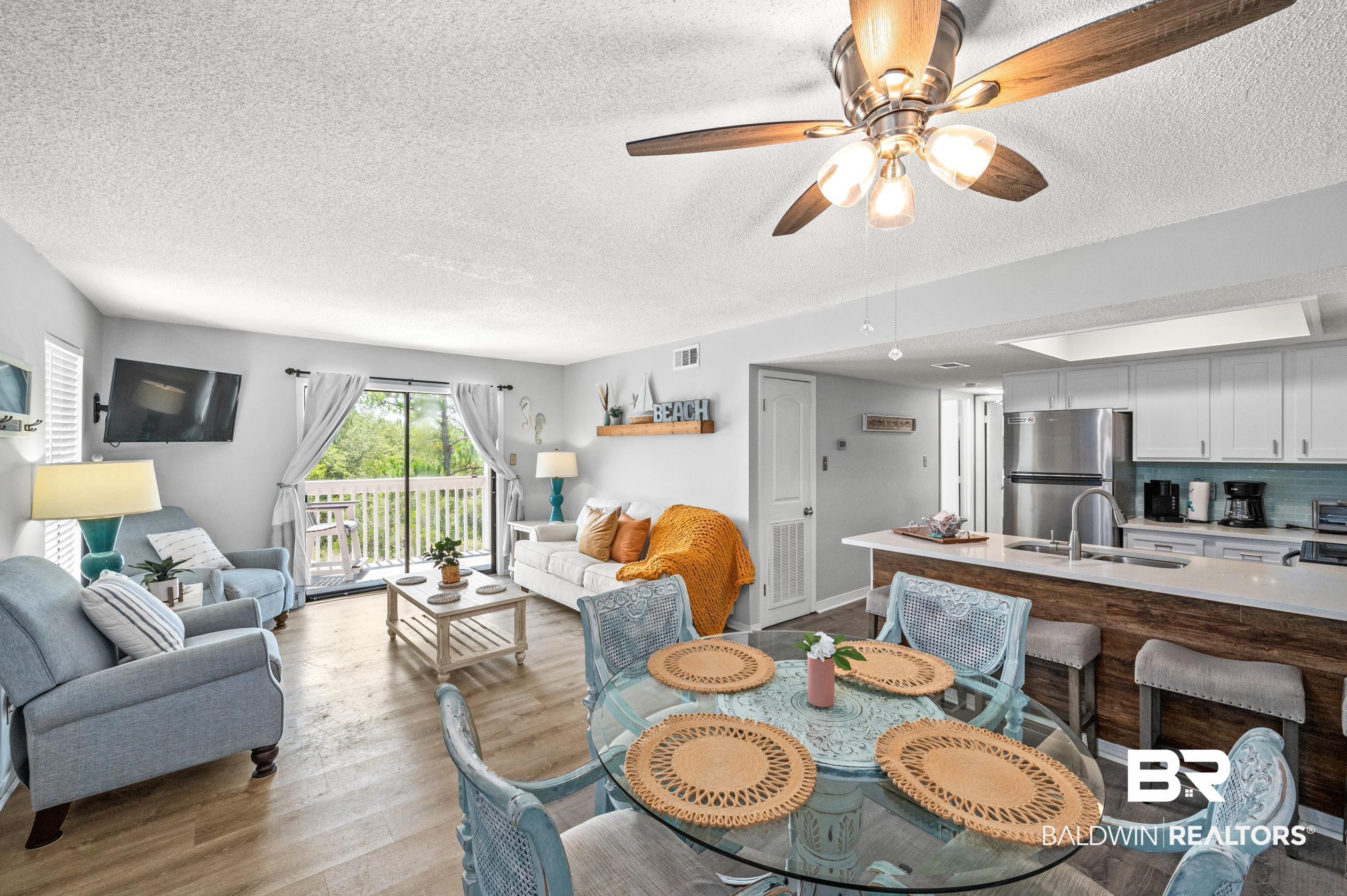 Image 4: Dining area with dark wood-type flooring, ceiling fan, and a textured ceiling