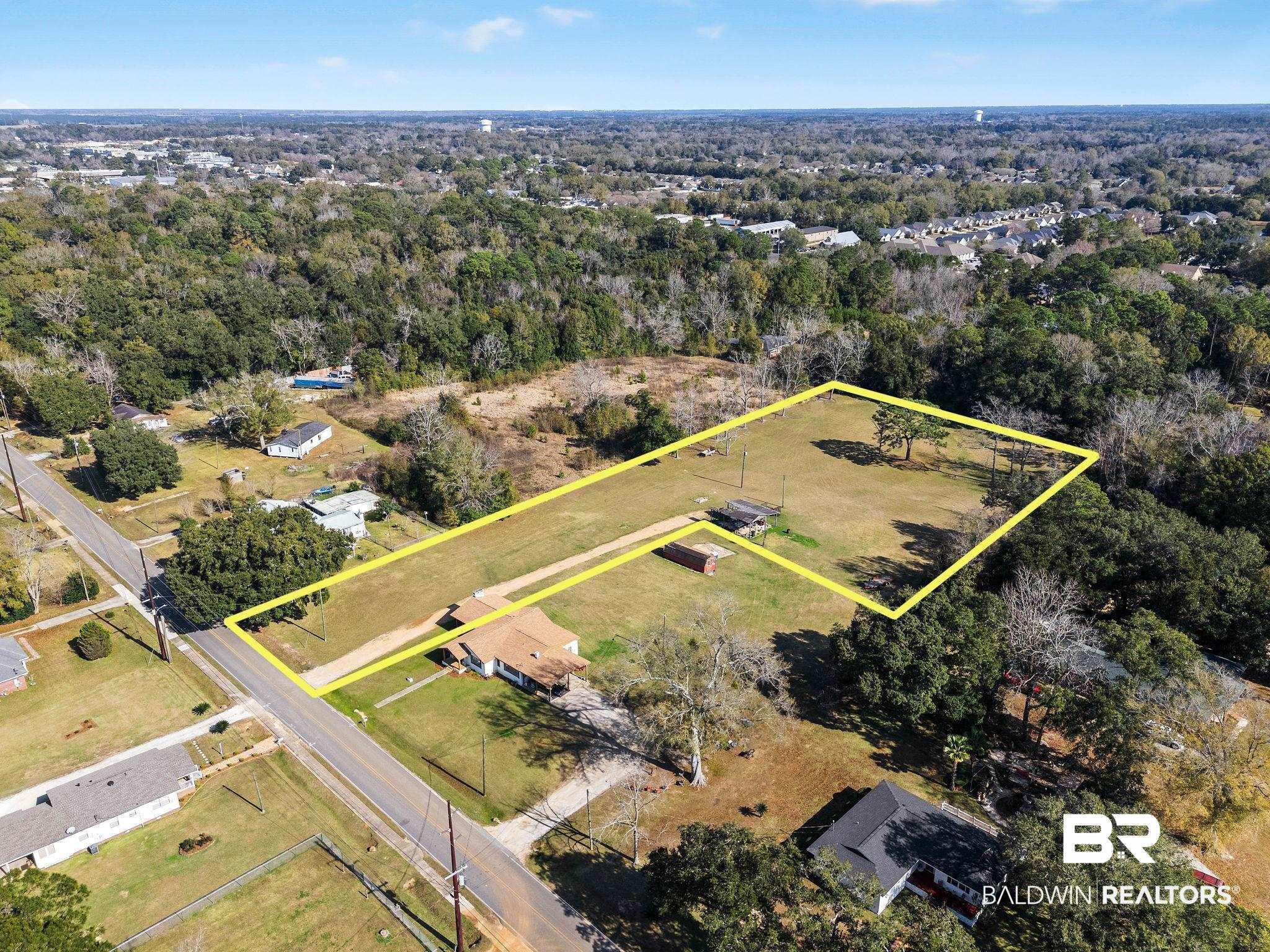 Image 4: Aerial view of property and surrounding area with property parcel outlined