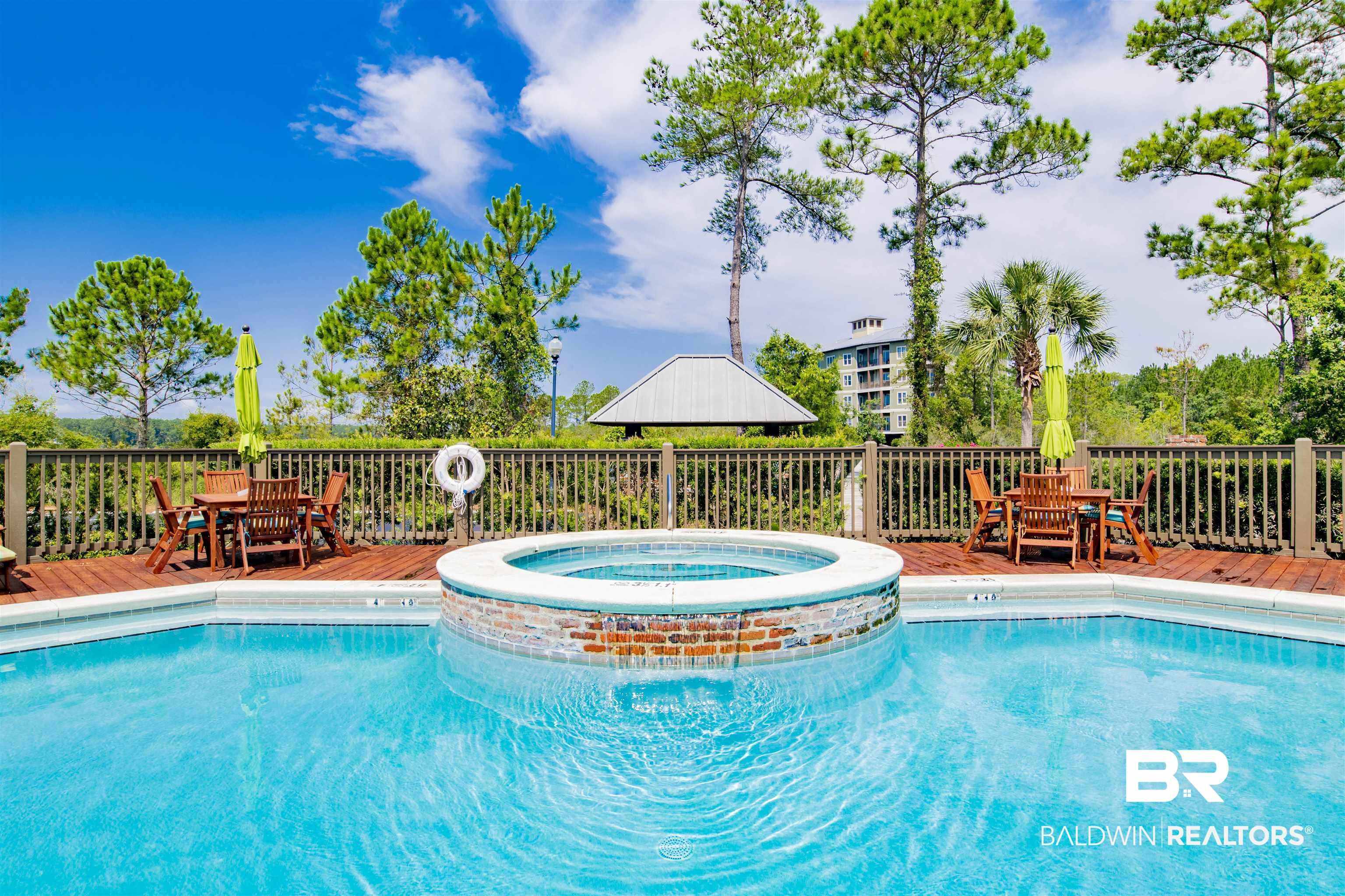 Image 2: Relaxing pool / spa featuring outdoor dining space and a deck