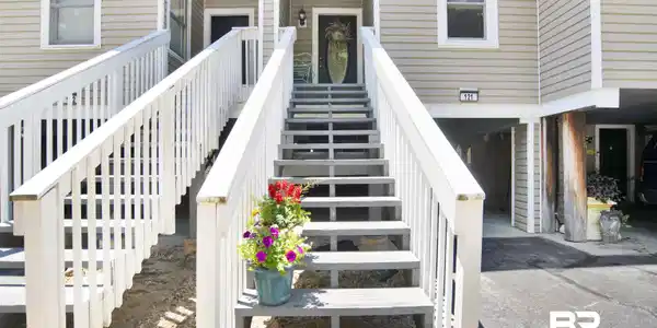 Image 3: Exterior facade featuring horizontal siding and white trim