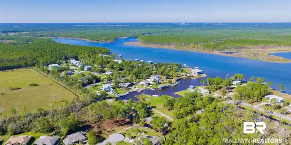 Image 3: Aerial view featuring a residential view, a water view, and a view of trees