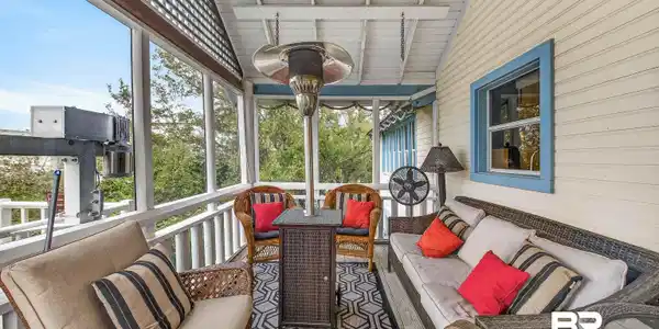 Image 3: Sunroom with outdoor furniture, a ceiling fan, plenty of natural light, and lofted ceiling with beams