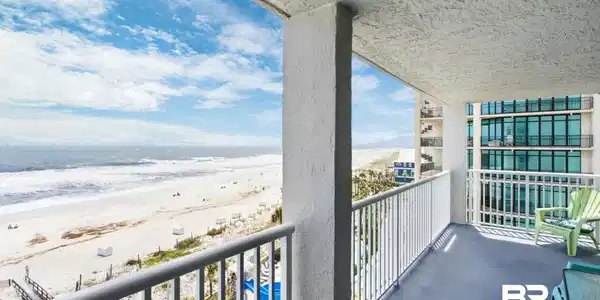 Image 4: Private balcony featuring a painted concrete floor, white metal railing, and direct oceanfront exposure