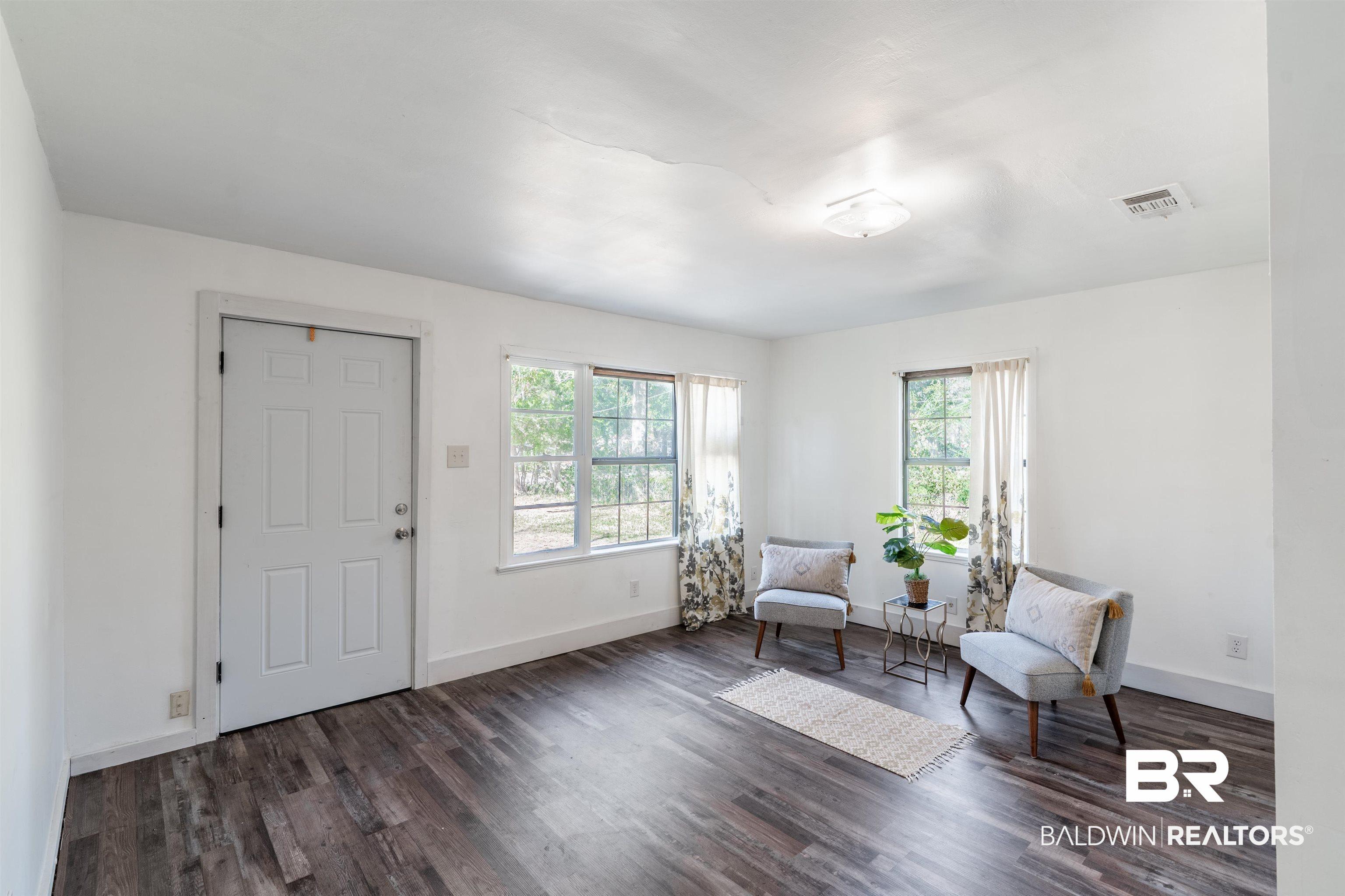 Image 3: Sitting room featuring plenty of natural light and dark wood finished floors