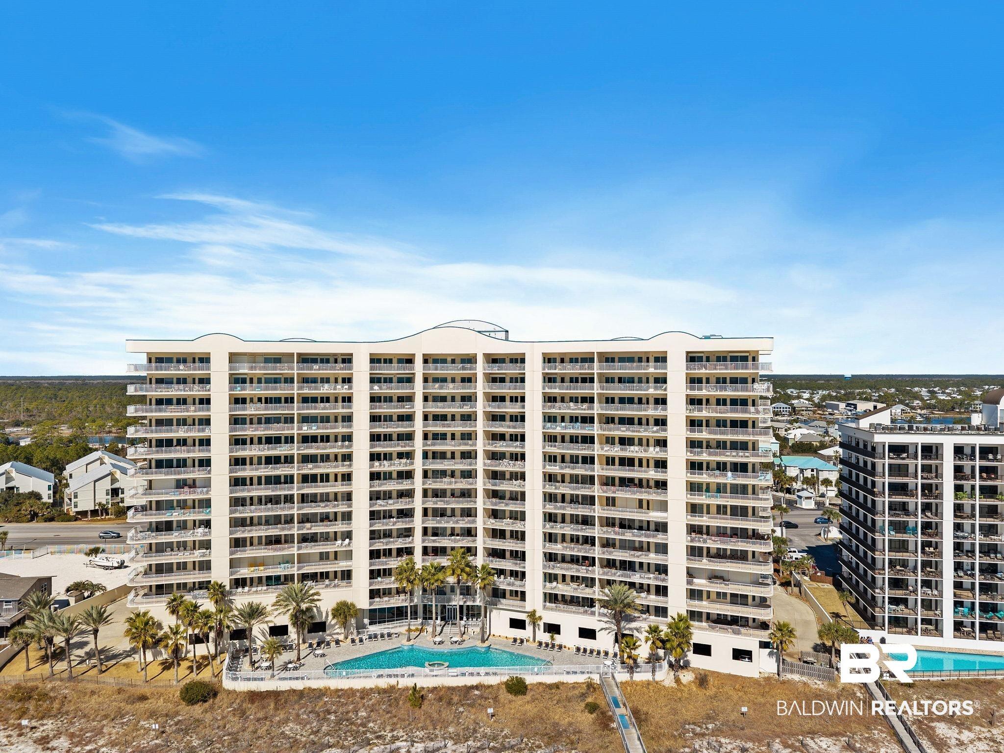 Image 1: View of apartment building / complex with a community pool