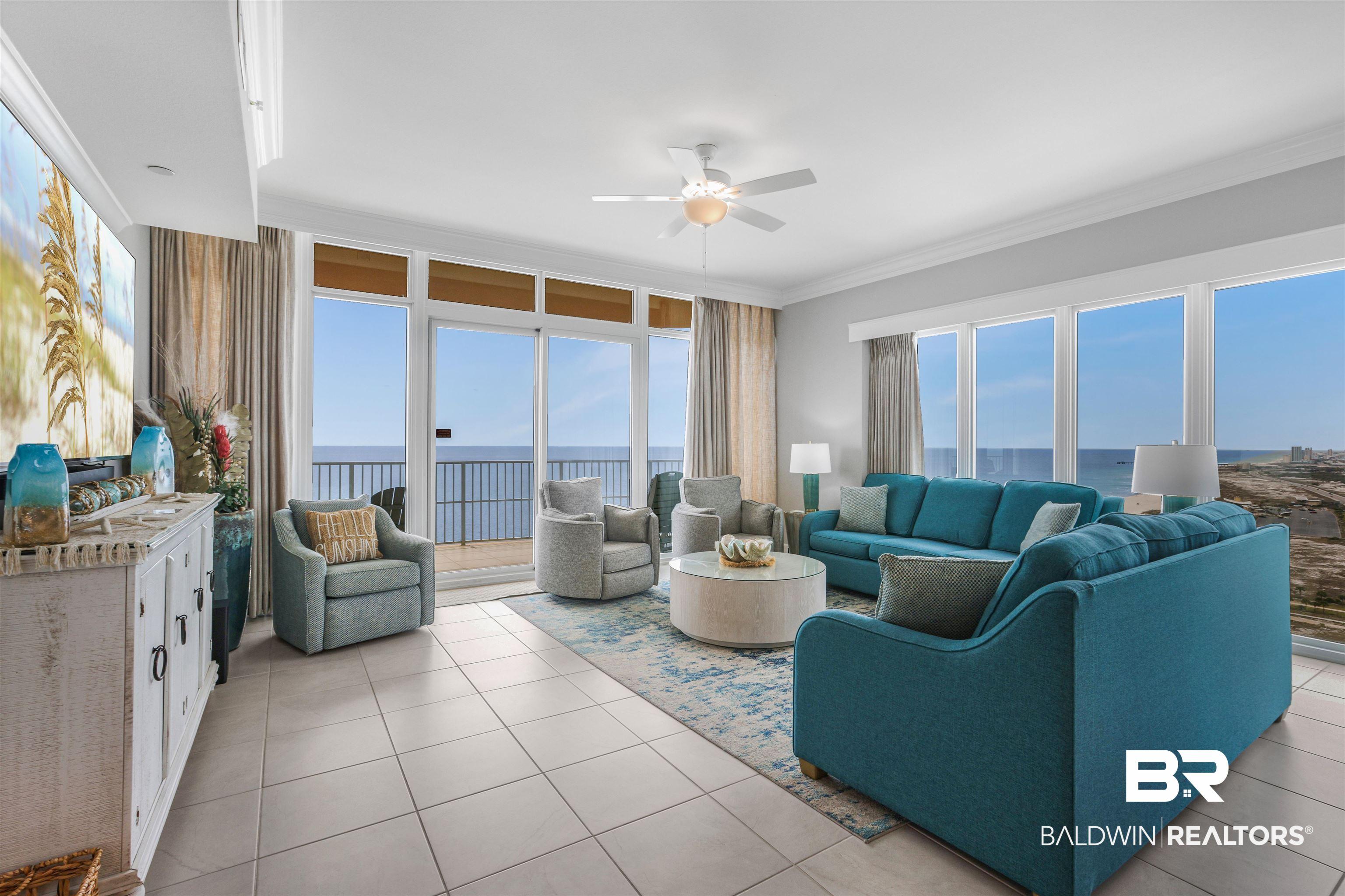 Image 3: Living area featuring a water view, ceiling fan, ornamental molding, and plenty of natural light