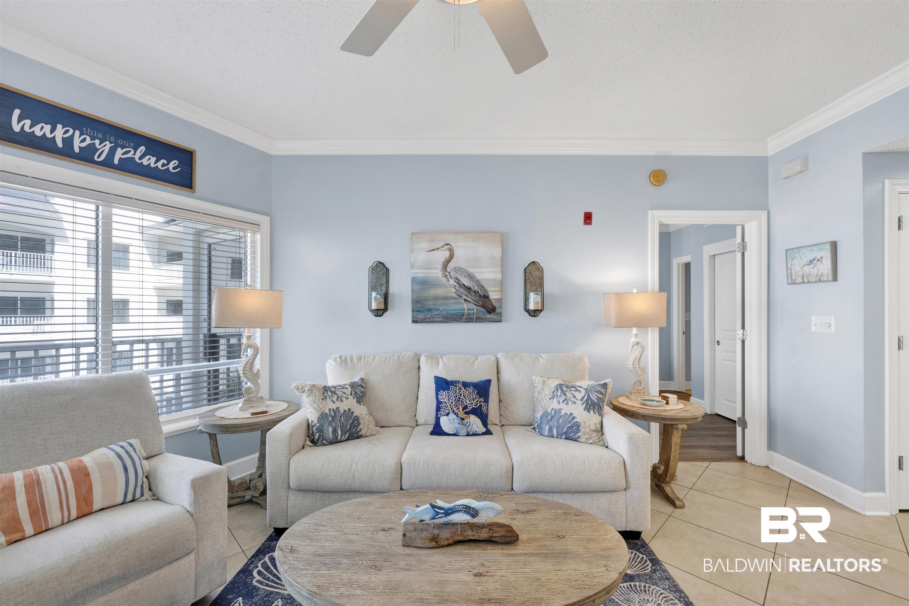 Image 3: Living area featuring large windows with horizontal blinds, ceiling fan, and tile flooring