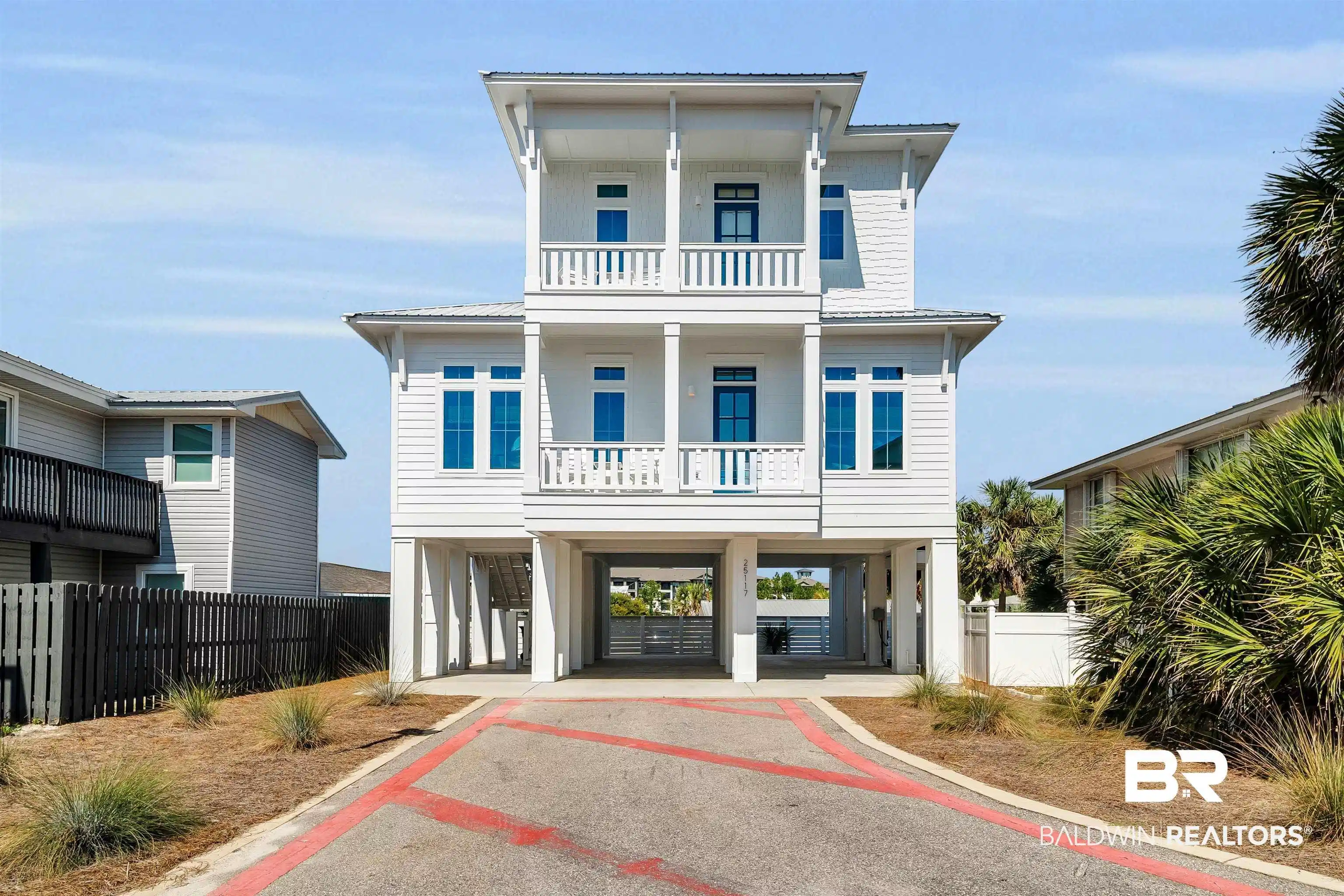 Image 1: View of front of property featuring a carport, driveway, and a metal roof